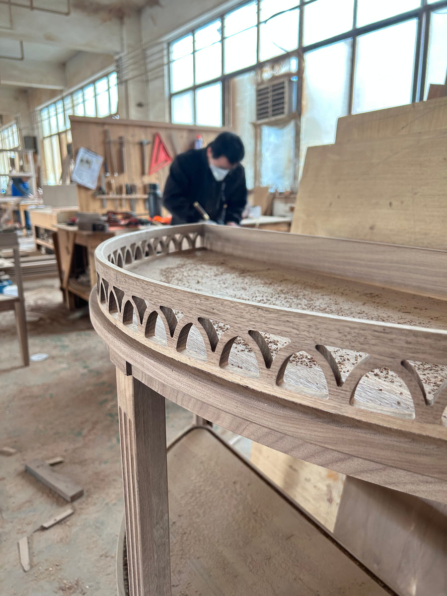 Natural wood grain and decorative openings along the unfinished cabinet edge