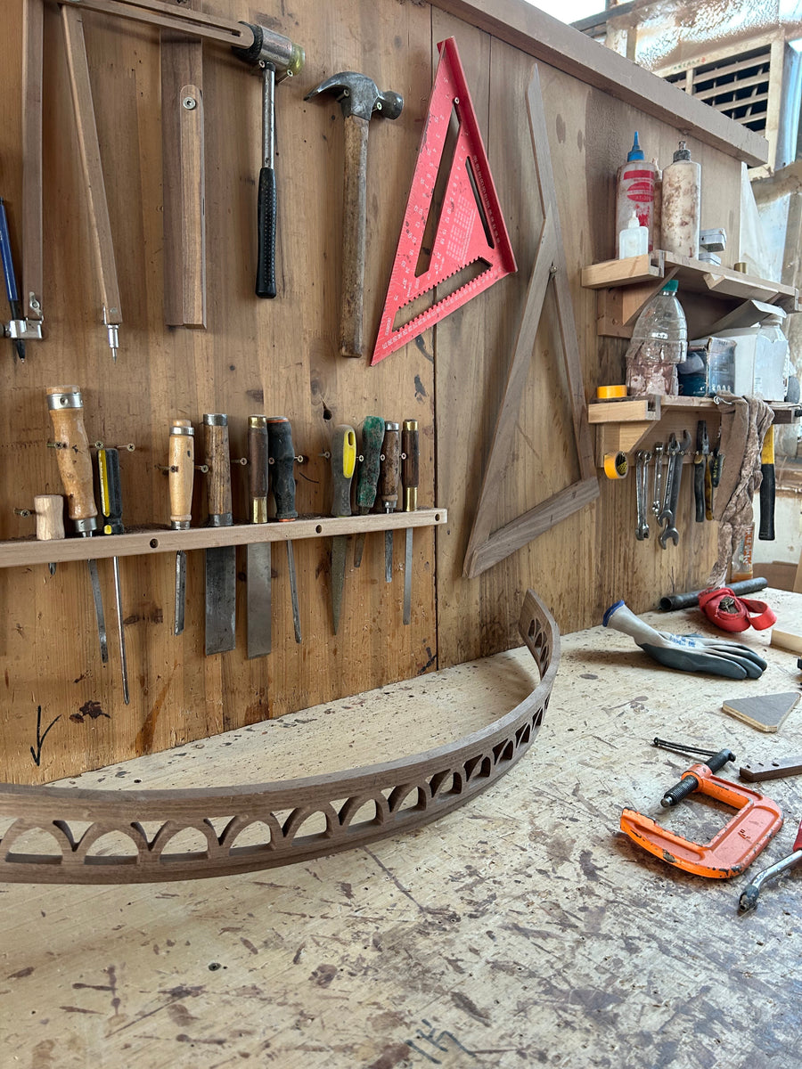 Workshop tools and a curved wooden component for the accent cabinet